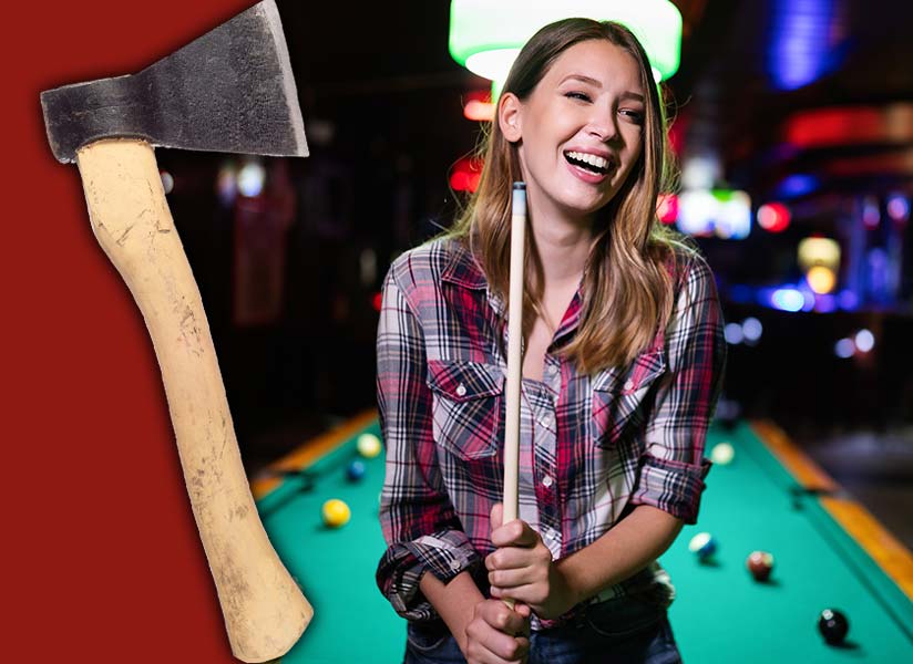 A woman pool billiards player holds the pool stick and smiles reading for her next shot.